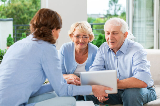 Senior couple having meeting with financial advisor at home.